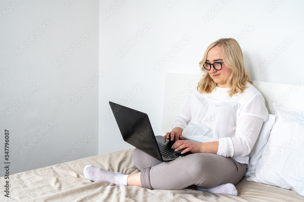 Blond woman working on laptop at home Blond woman working on laptop at home