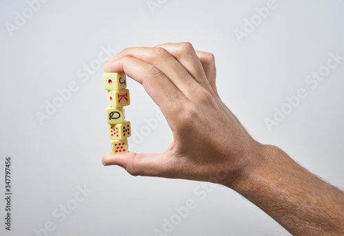hand throwing dice in the air on white background