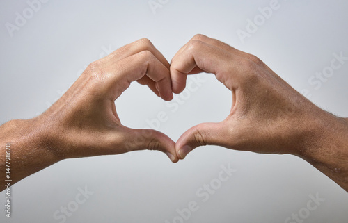 hands making heart shapes on white background
