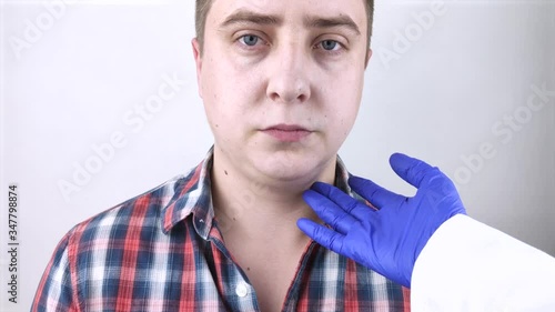 The man has a second chin. The concept of obesity and plastic surgery of the face. Close-up of a patient's sad face and his “fat” on his neck. photo