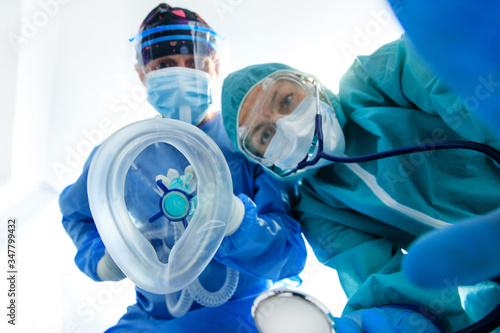 Giving first medical help in hospital. Doctors give resuscitation to patient in the emergency room photo