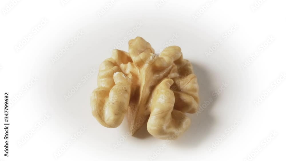 Still life with a walnut peeled on white background. Still life with a walnut peeled on white background.