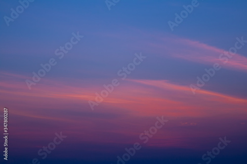sunset, gradient texture of the sky from dark blue to orange. © creativjf