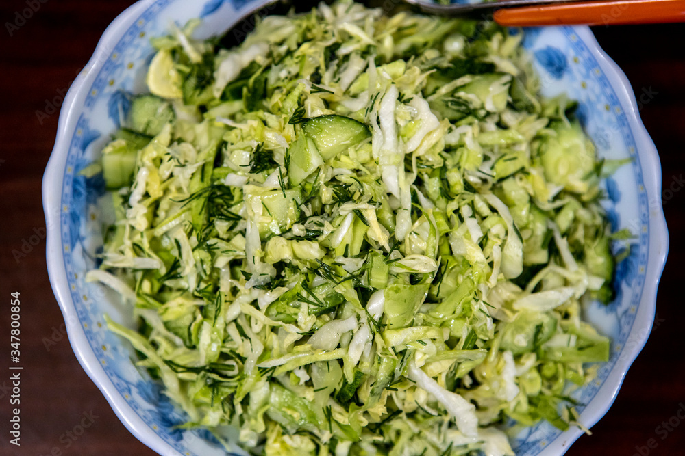 a full plate of green salad with cucumber and fresh cabbage a full plate of green salad with cucumber and fresh cabbage