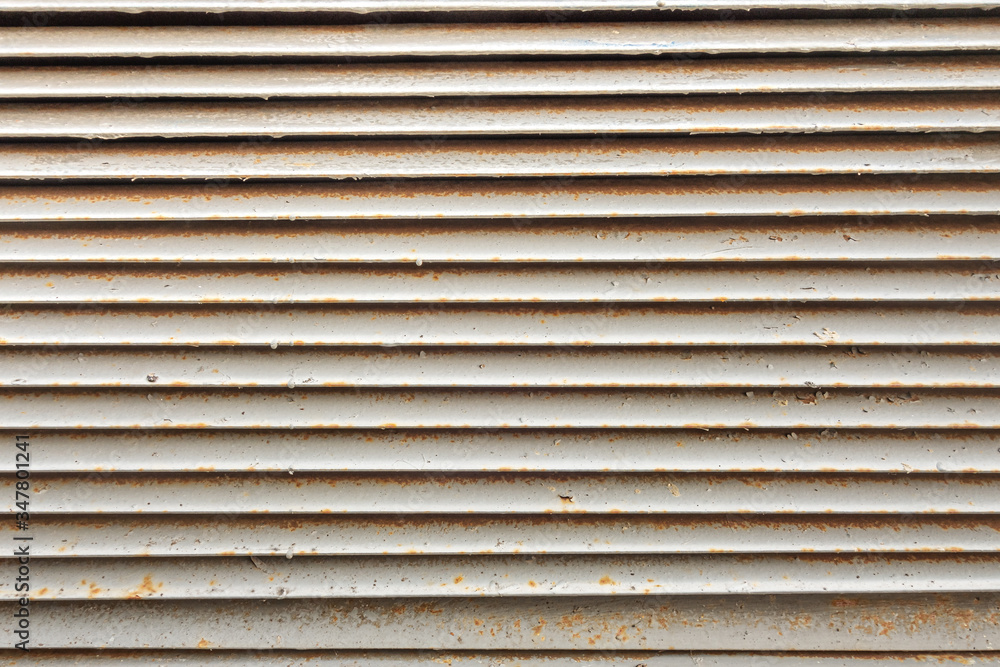 abstract background of an old ventilation grill in spots of rust close up abstract background of an old ventilation grill in spots of rust close up