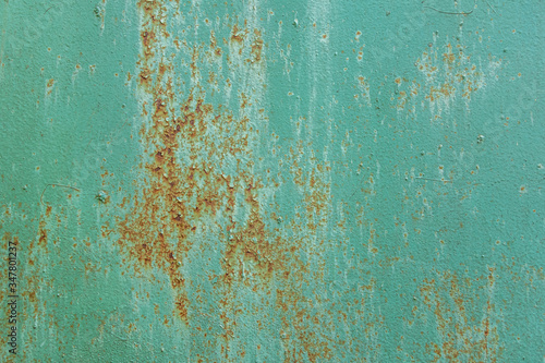 abstract background of an old turquoise rusty metal surface close up