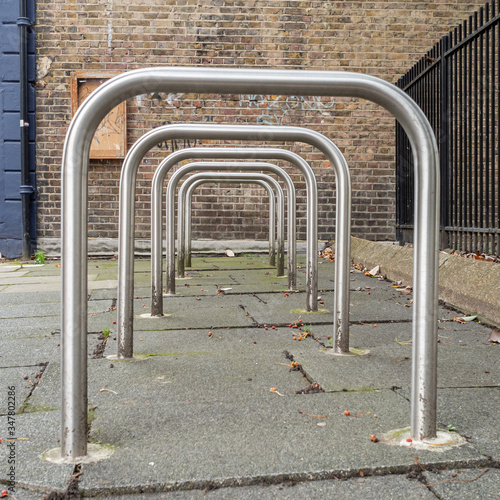 Row of empty Sheffield stand bike racks on the pavement