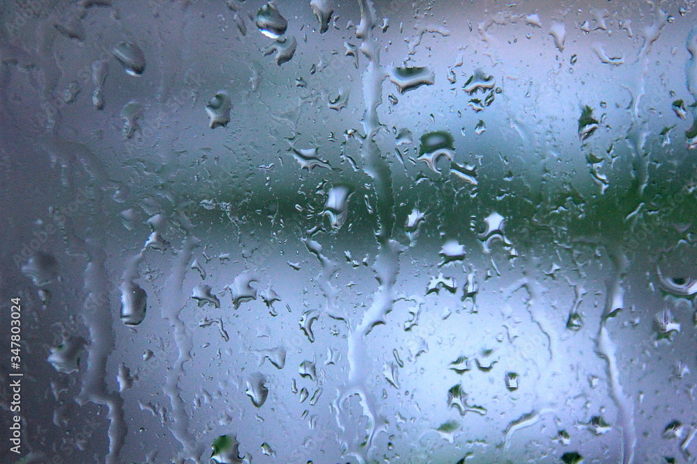 a rain-drenched window and the landscape out of focus behind it 2 a rain-drenched window and the landscape out of focus behind it 2