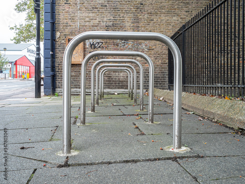 Row of empty Sheffield stand bike racks on the pavement