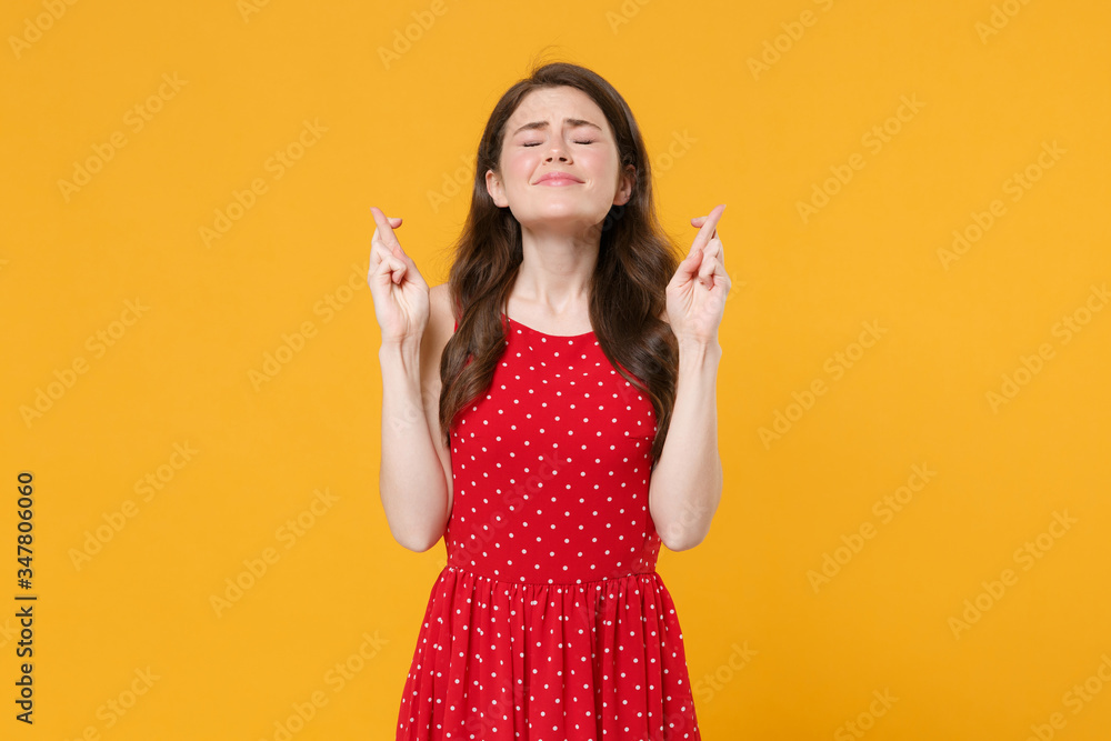 Young brunette woman girl in red summer dress isolated on yellow ...