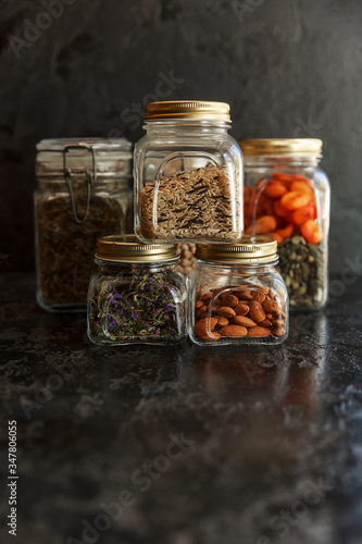 Food set. Raw cereals, pasta, groats, organic legumes and useful seeds in glass jars.