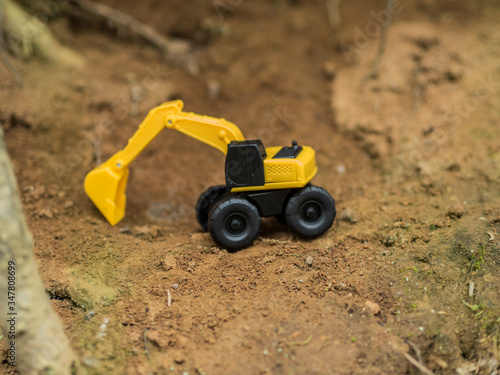 Toy construction machinery working on an excavation