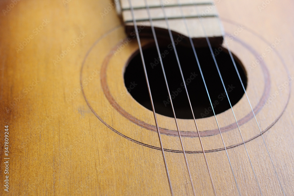 Sound hole of the guitar with the strings for the background. Sound hole of the guitar with the strings for the background.