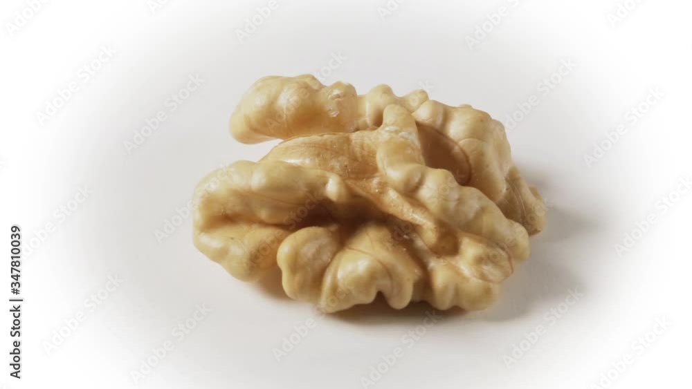 Still life with a walnut peeled on white background. Still life with a walnut peeled on white background.