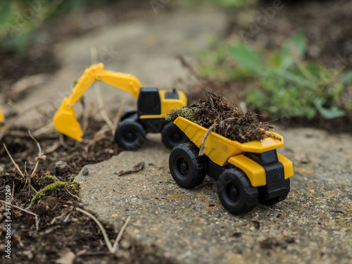 Toy construction machinery working on an excavation