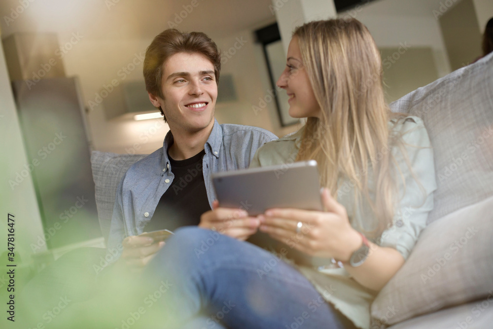 Young couple doing e-shopping on internet with tablet Young couple doing e-shopping on internet with tablet