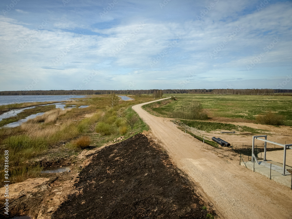 Fototapeta premium bright landscape with lake shore, flooded lake meadows, first spring greenery, wallpaper
