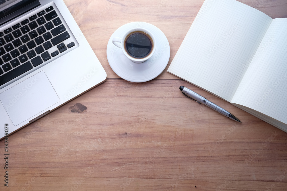 Top view of laptop, notepad, tea with copy space. Top view of laptop, notepad, tea with copy space.