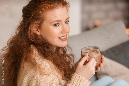 Beautiful young woman drink...
