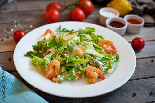 salad caesar with shrimps on white plate
