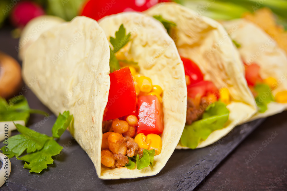 Mexican tacos with chicken meat, beans, tomatoes and corn Mexican tacos with chicken meat, beans, tomatoes and corn