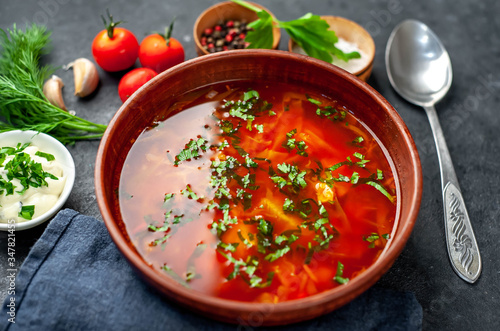 Borscht - Traditional Ukrainian dish in a plate on a stone background