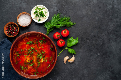 Borsch - Traditional Ukrainian dish in a plate on a stone background with copy space for your text