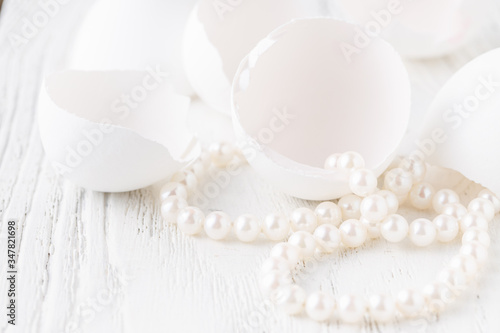 Bunch round white shiny pearls with white background