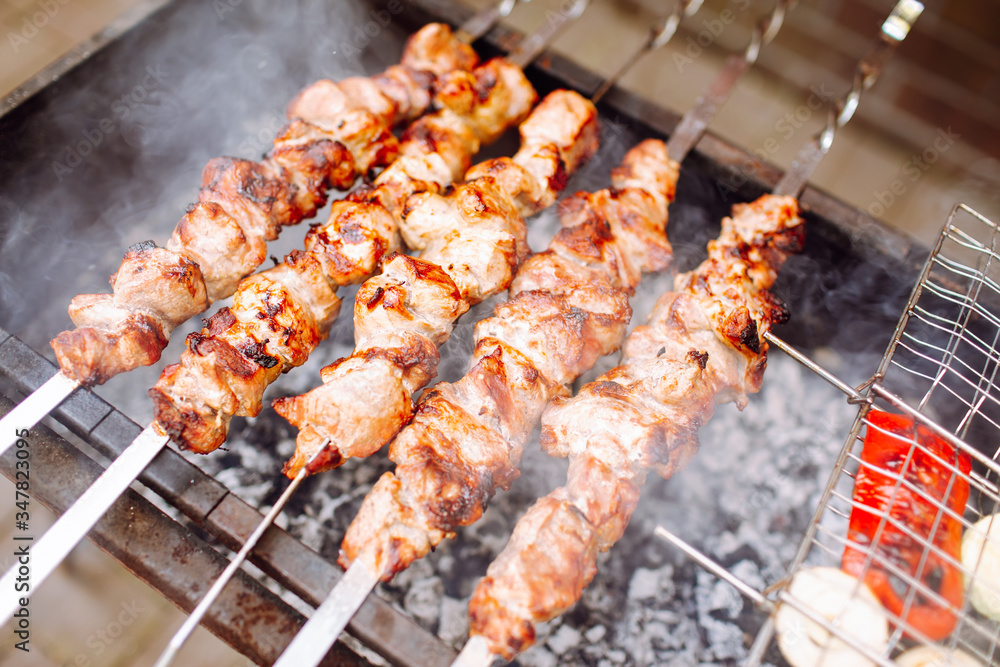 Bbq kebab grilling on open grill, outdoor kitchen. Food festival in city.