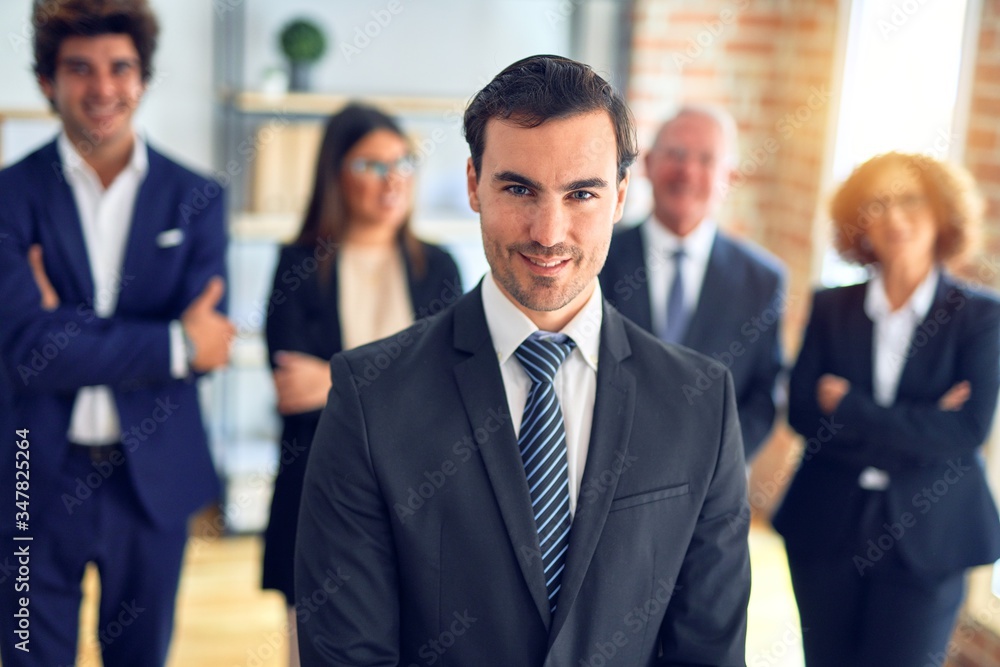Group of business workers smiling happy and confident in a meeting. Standing with smile on face looking at camera at the office. Group of business workers smiling happy and confident in a meeting. Standing with smile on face looking at camera at the office.