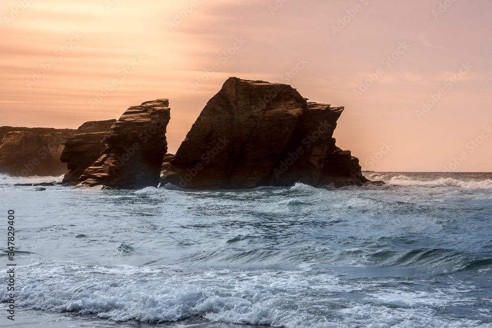 sunset lovely rock formation at praia de aguas santas beach