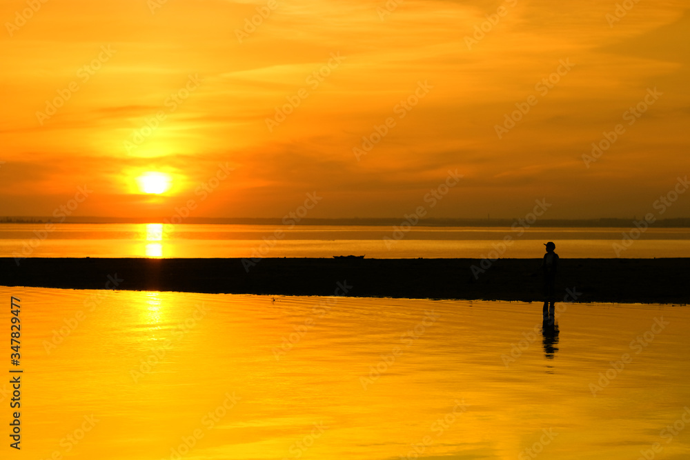 Beautiful child on sunset beach looking into the distance Beautiful child on sunset beach looking into the distance