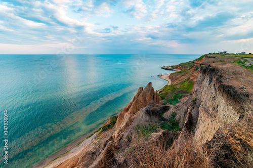 Picturesque sea coast with sand cliffs