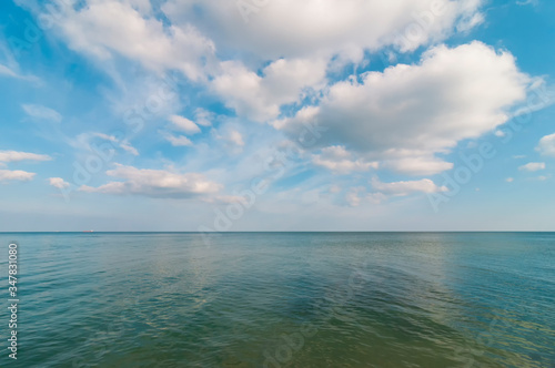 Endless sea and blue sky with clouds