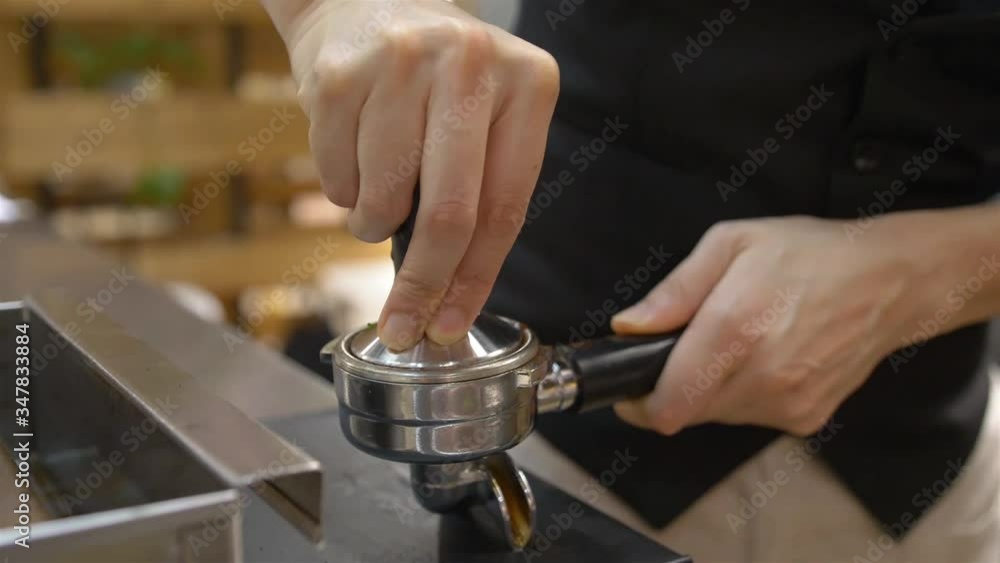 woman picking up lever and compressed it - pan follow woman picking up lever and compressed it - pan follow