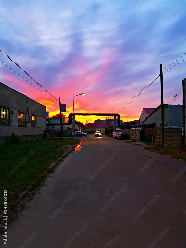 Obraz premium Industrial urban street in the evening light, with vintage warehouses and factories