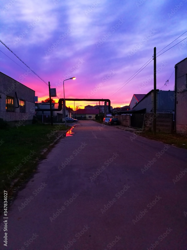 Fototapeta premium Industrial urban street in the evening light, with vintage warehouses and factories