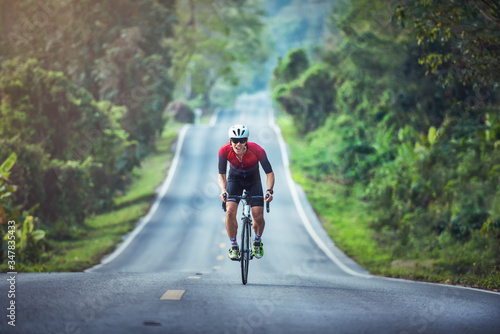 Fototapeta Naklejka Na Ścianę i Meble -  Cycling competition, cyclist athletes riding a race at high speed on mountain road, Sportsmen bikes in the morning,