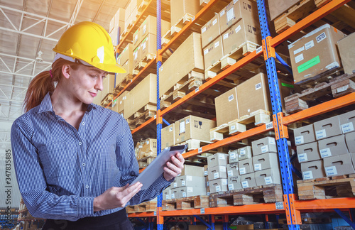 Fotografie Woman warehouse worker with a tablet.