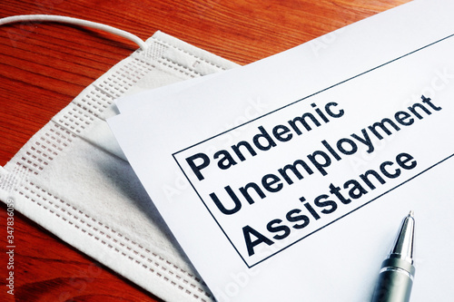 Obraz na plátně Pandemic Unemployment Assistance PUA papers and medical mask.