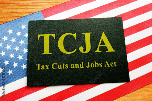 Tax Cuts and Jobs Act TCJA sign on the flag. photo