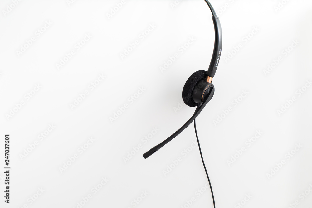 VOIP headset, pen and notebook on laptop computer keyboard. Communication support for callcenter and customer service Helpdesk. VOIP headset, pen and notebook on laptop computer keyboard. Communication support for callcenter and customer service Helpdesk.