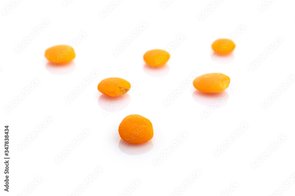 Grains lentils organic seeds isolated on white. Pile healthy orange pea background. Clean-eating food with antioxidant, omega-3, protein and copy space. Grains lentils organic seeds isolated on white. Pile healthy orange pea background. Clean-eating food with antioxidant, omega-3, protein and copy space.