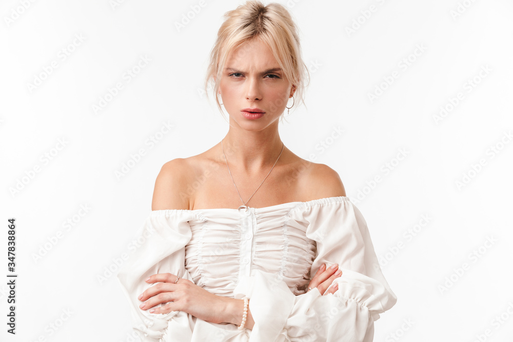 Image of beautiful displeased woman posing with hands crossed Image of beautiful displeased woman posing with hands crossed