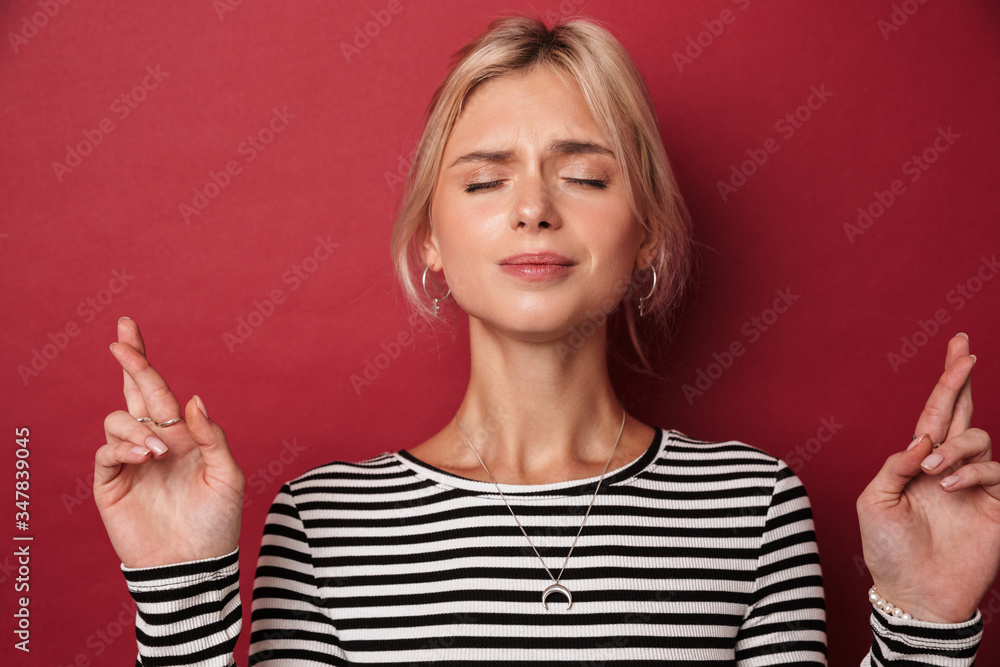Image of nice charming woman posing with fingers crossed for good luck Image of nice charming woman posing with fingers crossed for good luck