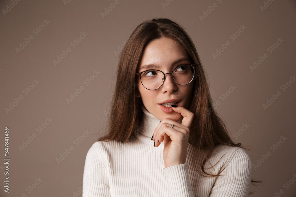 Photo of thinking beautiful woman posing and looking aside Photo of thinking beautiful woman posing and looking aside