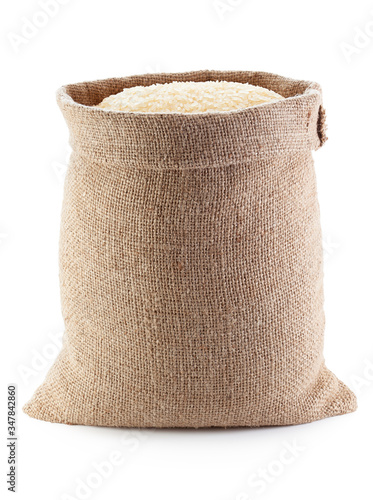Canvastavla Rice in burlap sack, isolated on the white background.