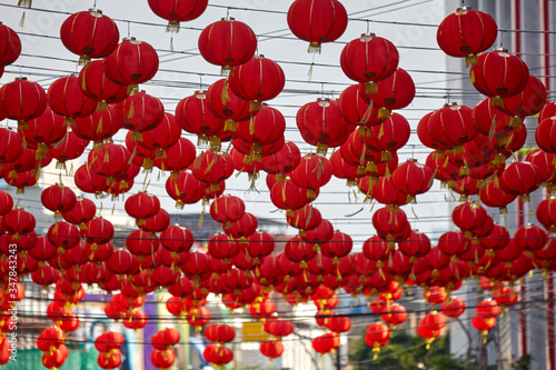red chinese lanterns hanging on the street in the city