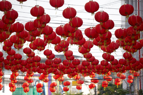 red chinese lanterns hanging on the street in the city
