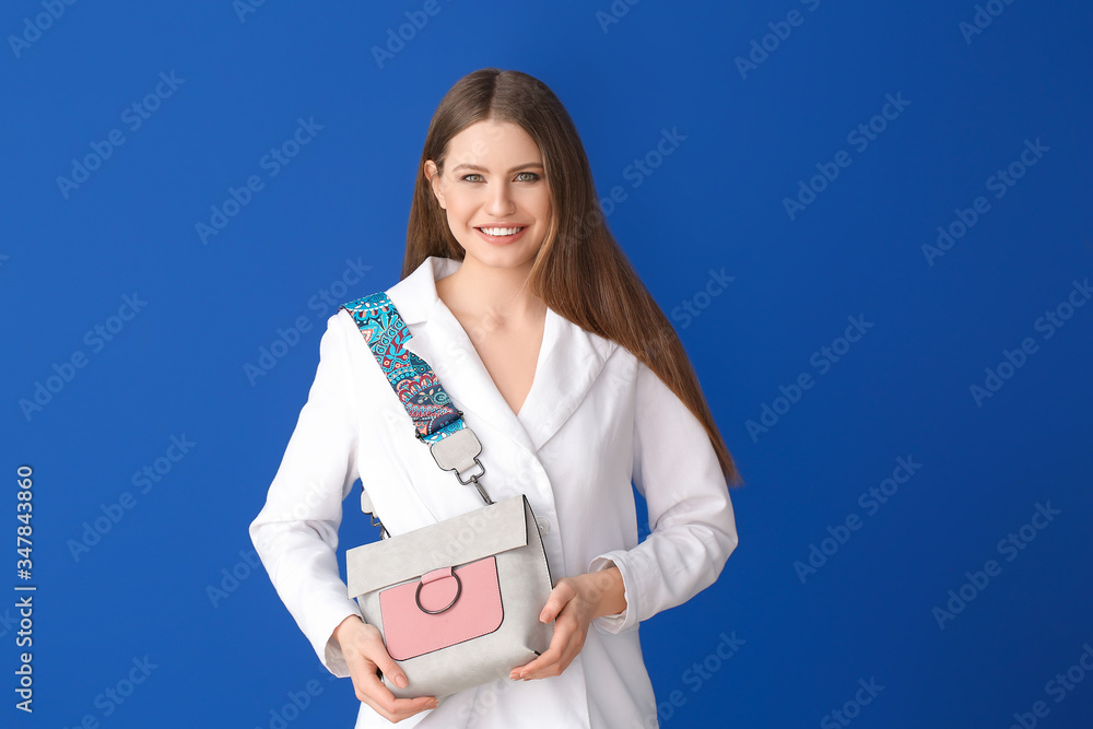 Beautiful woman with stylish bag on color background Beautiful woman with stylish bag on color background